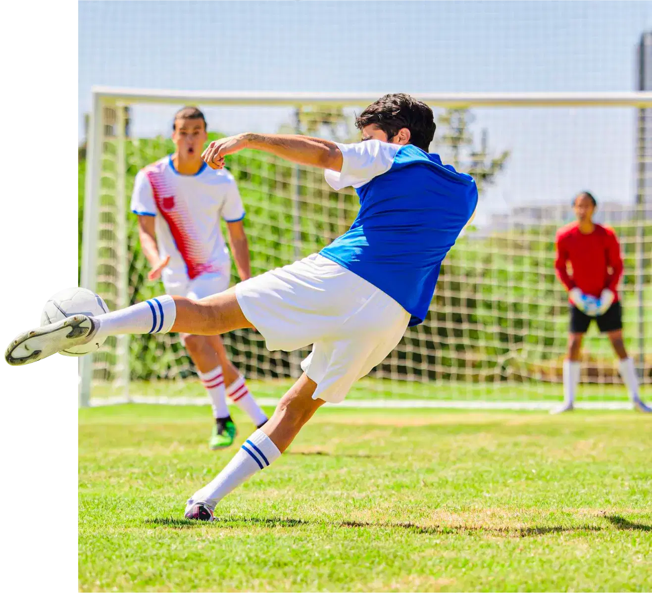 Player shoots the ball in front of a defender and a goalkeeper